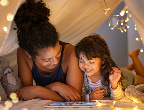 mother and daughter playing with a tablet