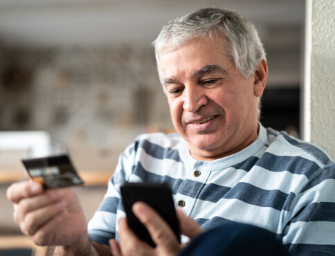 an elderly man making a mobile purchase